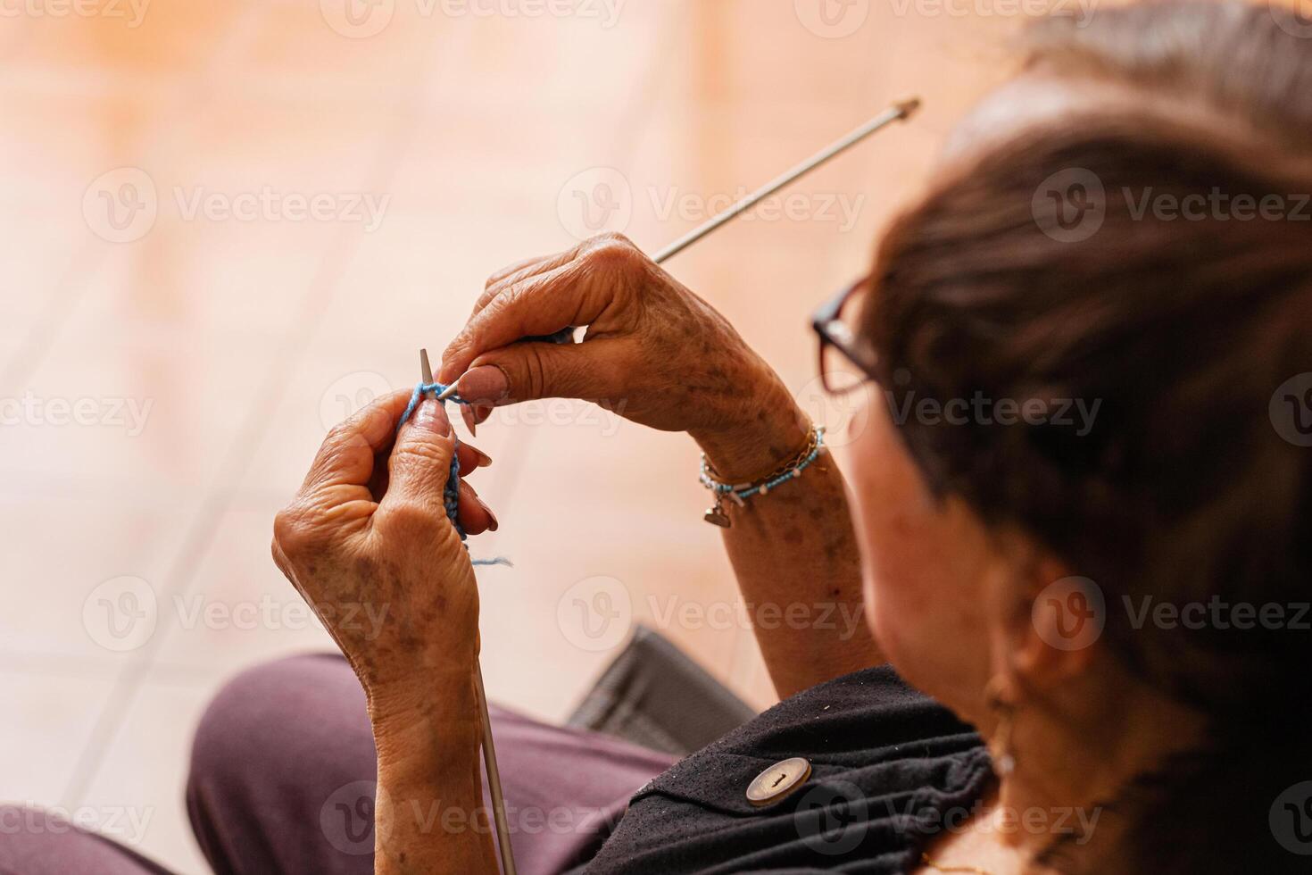 Timeless textures. Elderly hands weave tales in yarn. photo