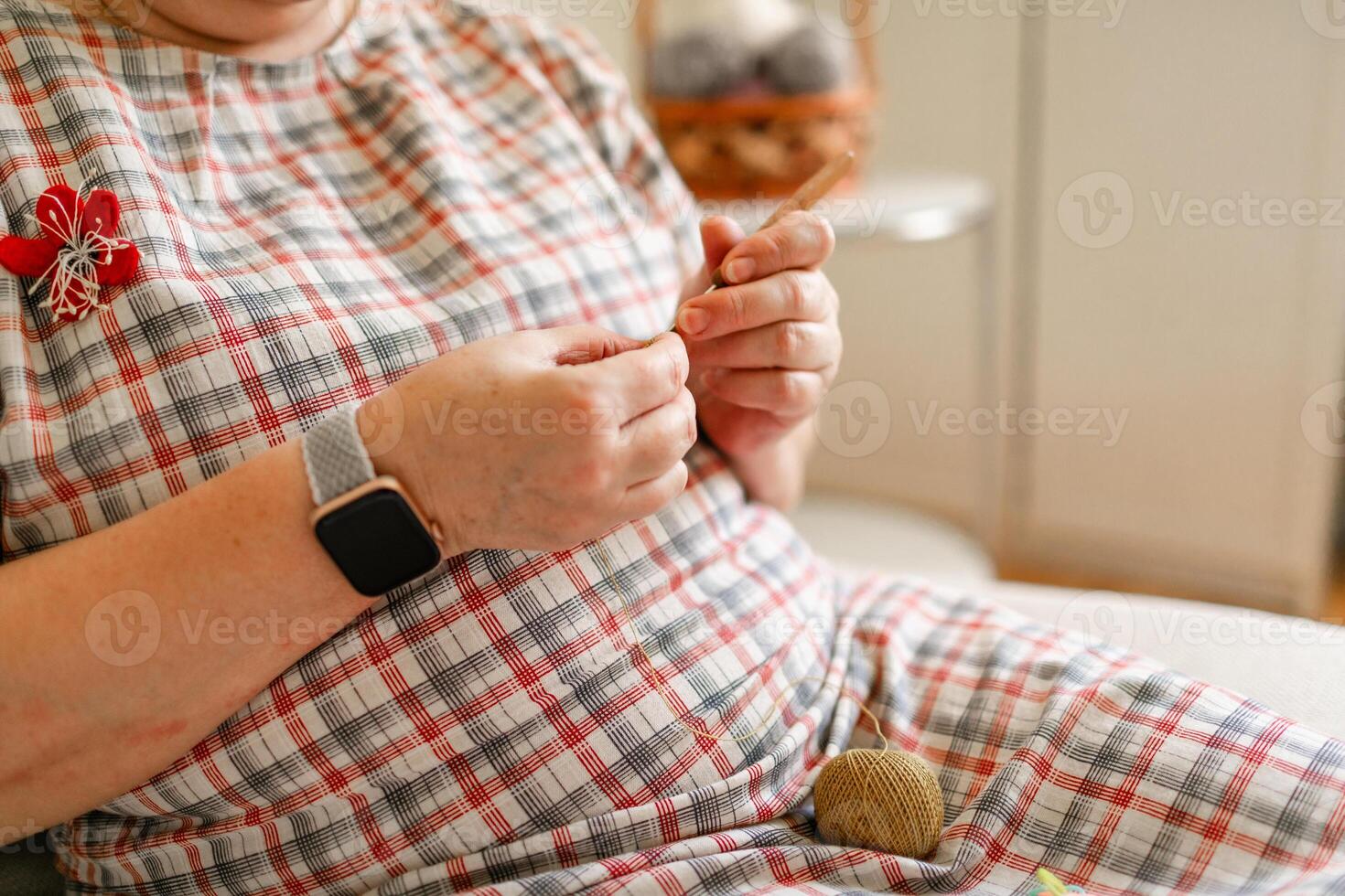 Close-up view of hands of an senior older woman crocheting. photo