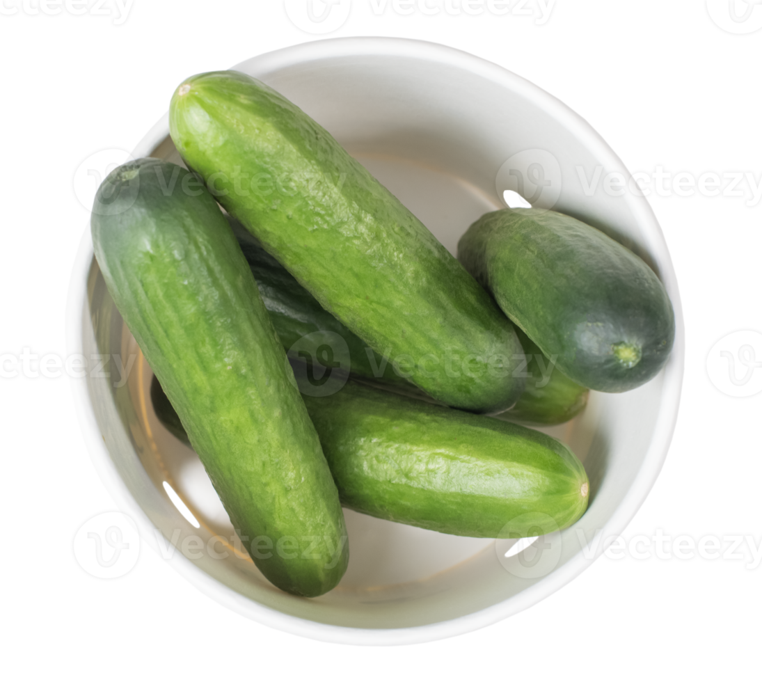 Several freshly picked cucumbers lying in white cardboard packaging, top view of fresh garden vegetables ready for culinary use isolated on transparent background, png