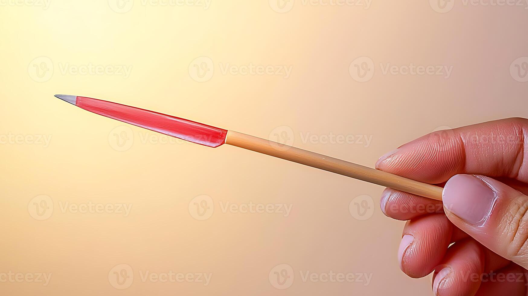 Close-up of a hand holding a colorful pen against a soft gradient background photo
