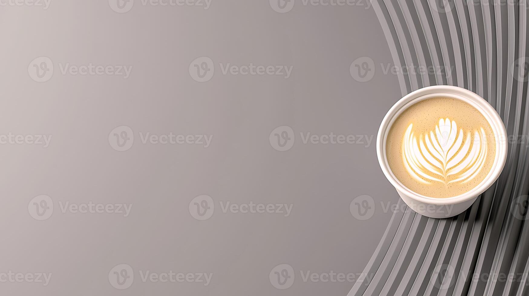 A beautifully crafted latte art in a white cup placed on a smooth, curved gray surface photo