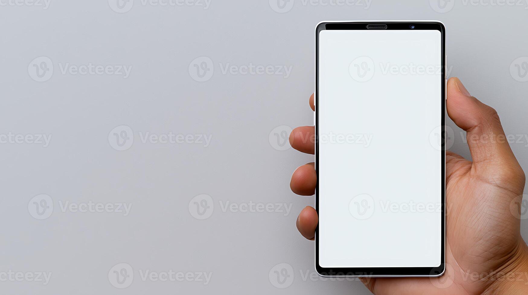 A person holding a blank smartphone against a neutral background, ideal for technology showcases photo