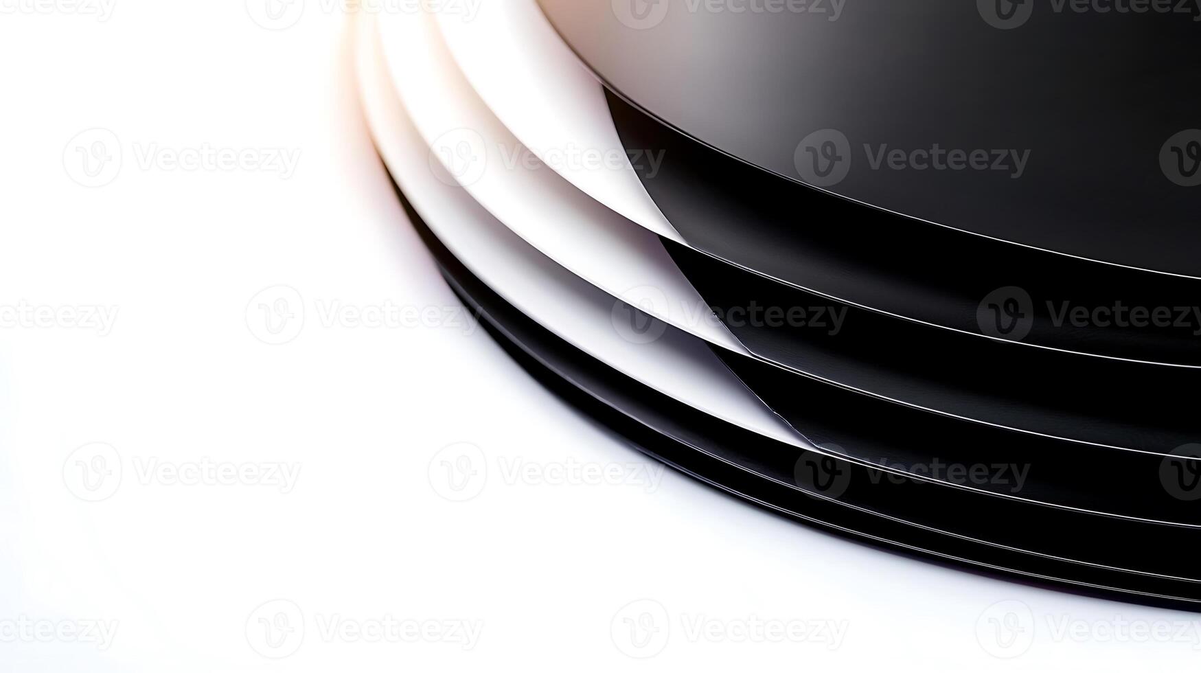 Close-up view of layered black and white plates creating a sleek, modern aesthetic on a clean surface photo