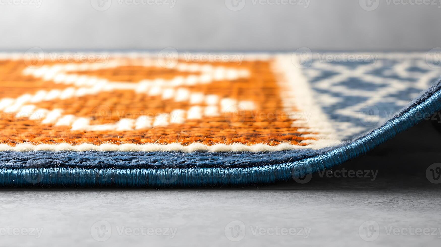 Close-up view of a vibrant patterned rug with intricate designs and textures on a neutral background photo