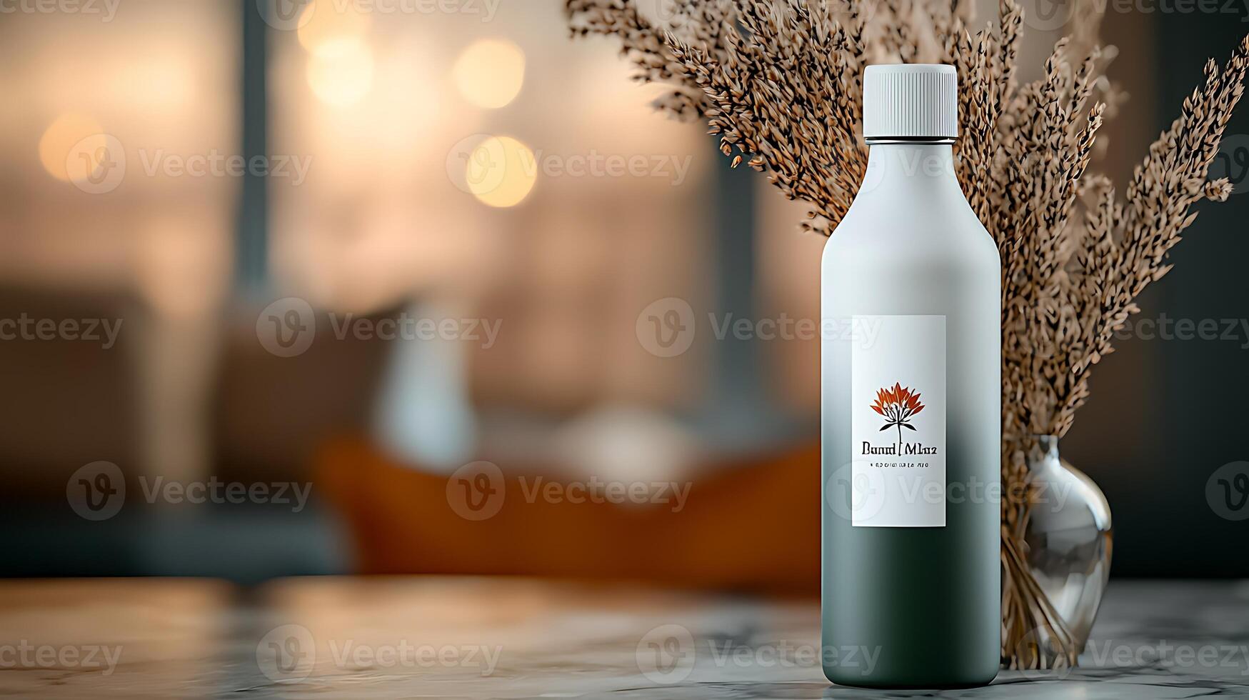 Elegant glass bottle with a minimalist design, surrounded by dried flowers in a cozy interior setting photo