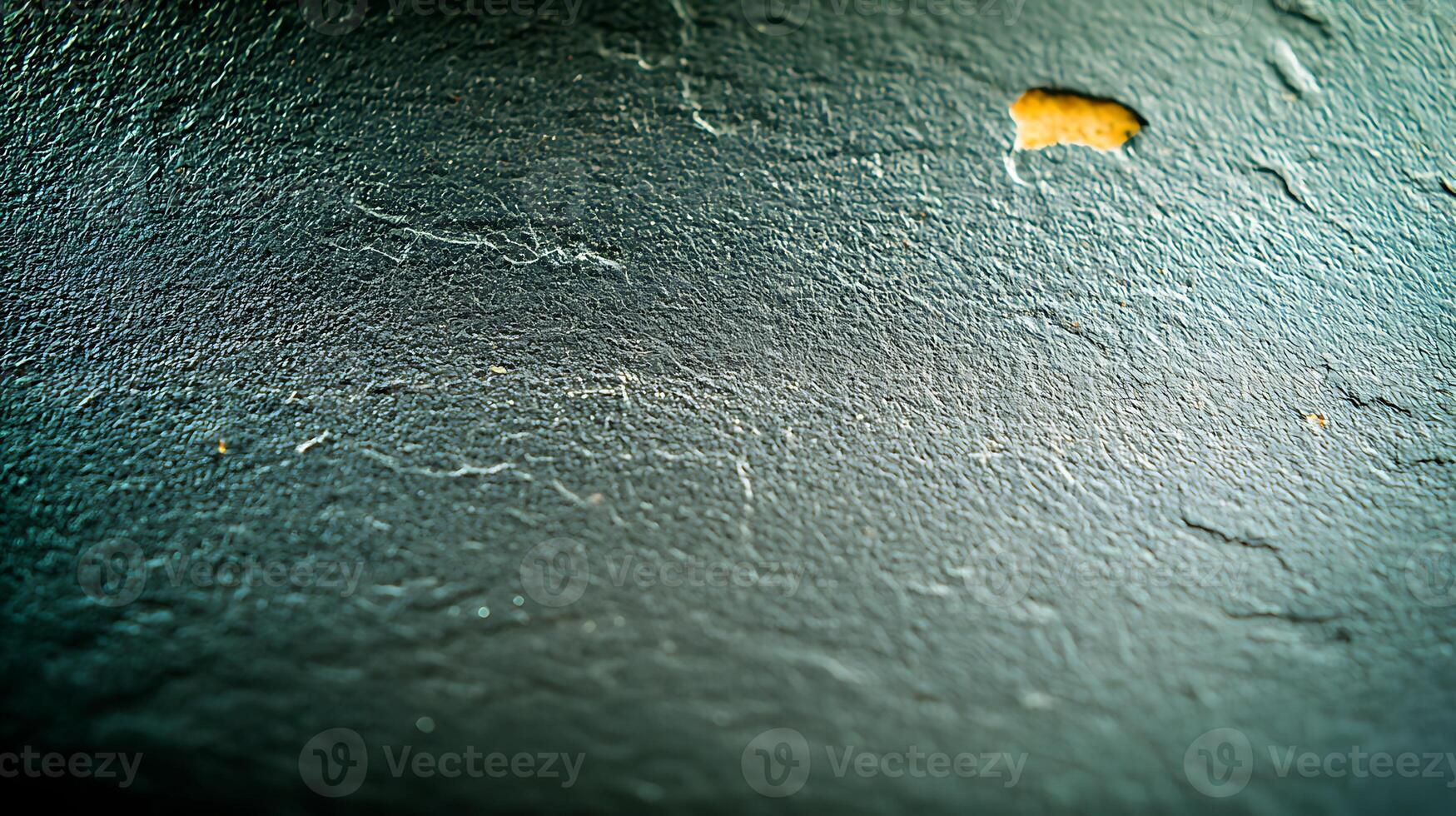 Close-up of textured wall surface with subtle scratches and a small orange blemish photo