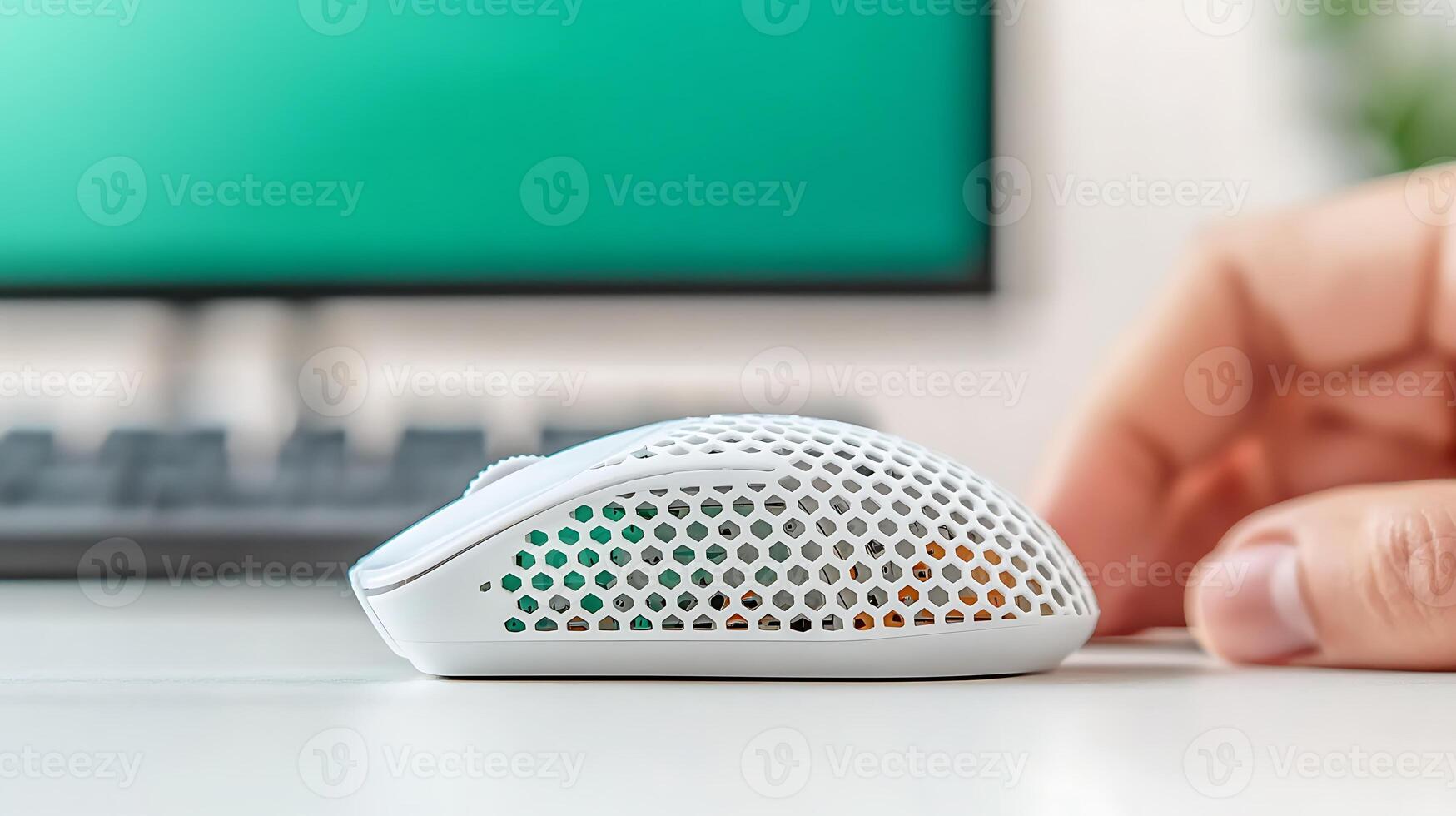 Sleek white gaming mouse on a desk with a blurred computer monitor in the background photo