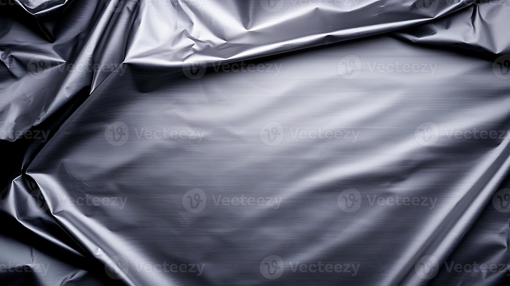 Black crumpled plastic sheet with subtle texture, ideal for backgrounds or product photography photo