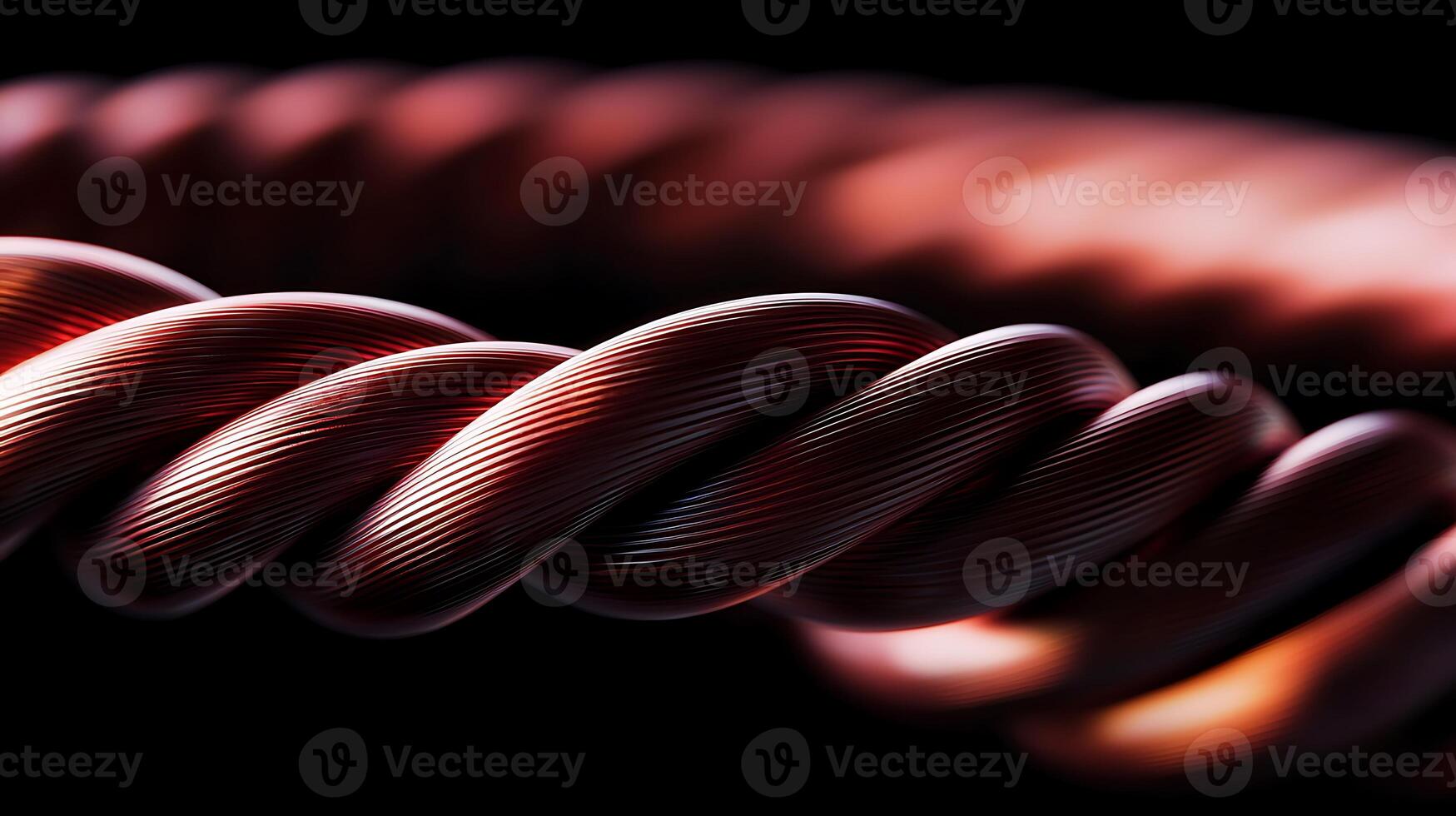 Close-up of a twisted copper wire coil against a dark background, showcasing its texture and shine photo