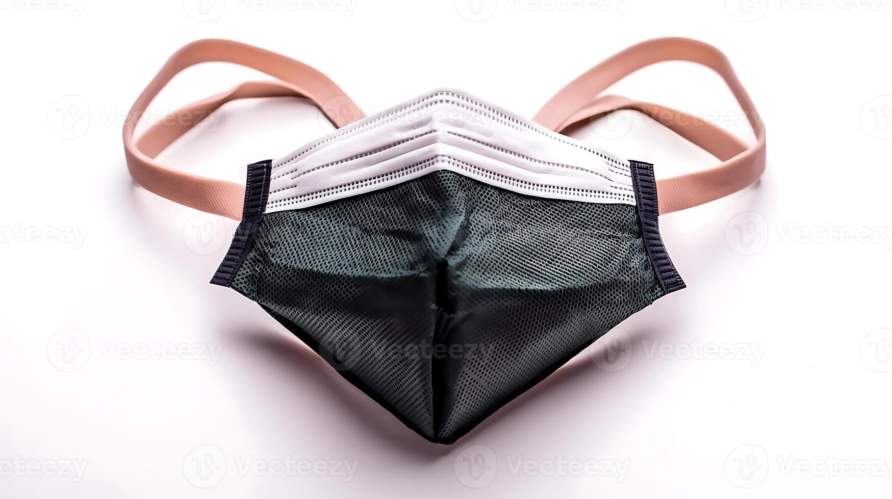 Close-up view of a black face mask with pink straps on a white background, symbolizing safety photo