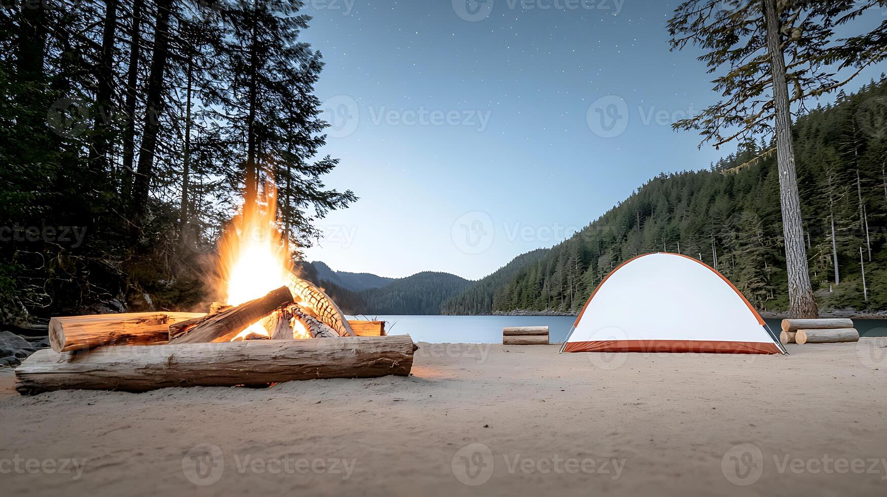 Serene lakeside camping scene at dusk with a glowing campfire and a white tent photo