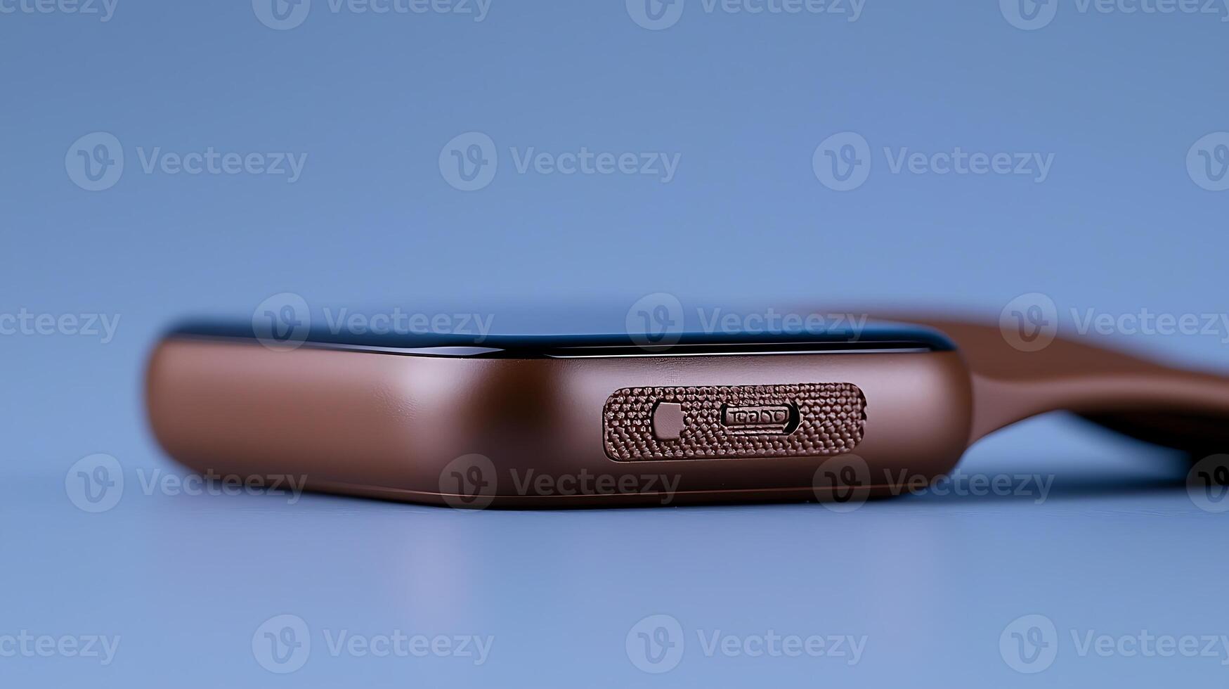 Close-up of a sleek brown smartphone with a textured side button against a soft blue background photo