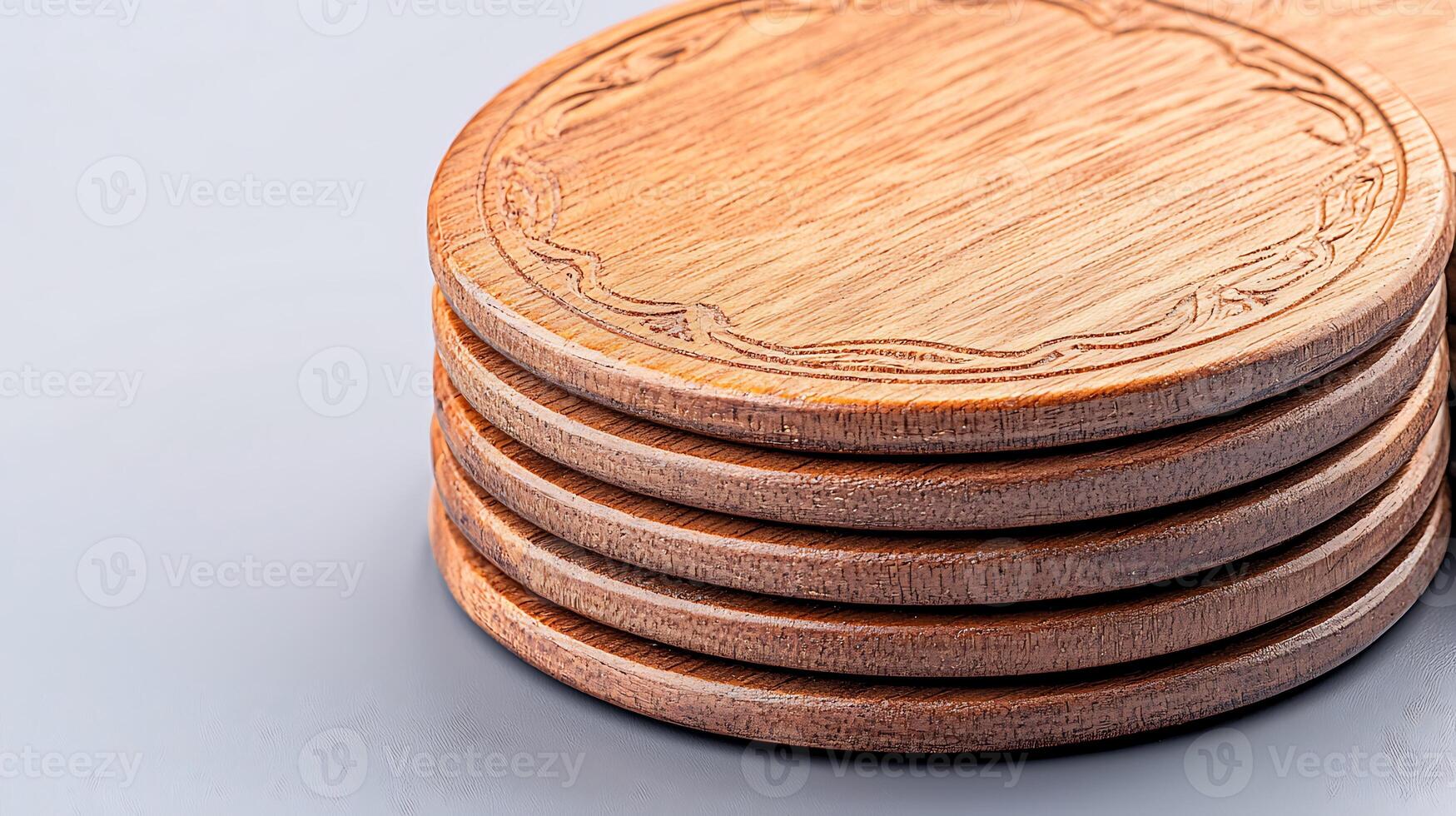 Stacked wooden coasters with intricate design resting on a smooth surface, ideal for home decor photo