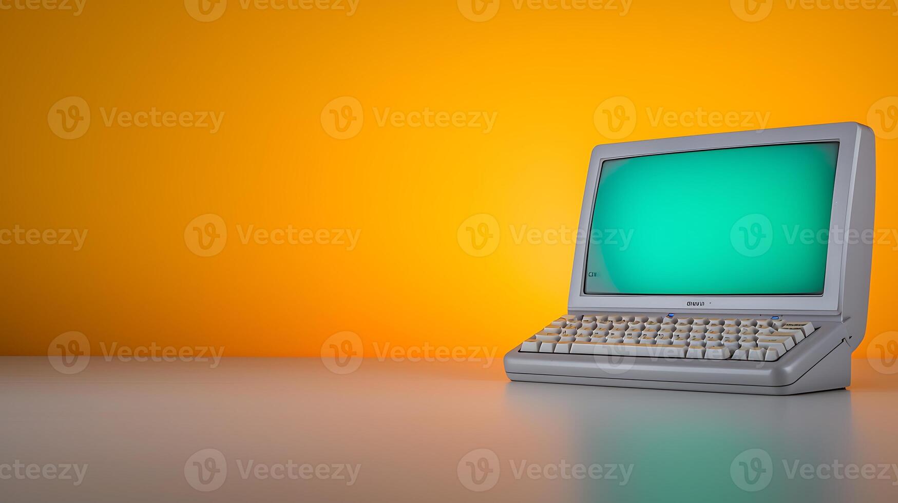 Vintage computer on a sleek surface against a vibrant orange backdrop, showcasing retro technology photo