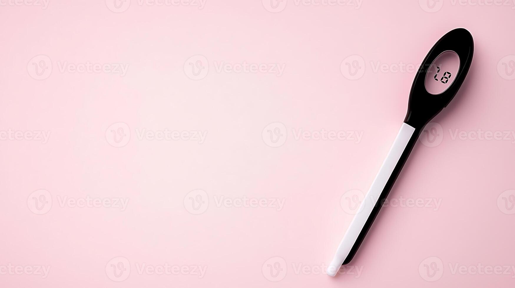 Digital thermometer resting on a soft pink surface, indicating temperature for health monitoring photo