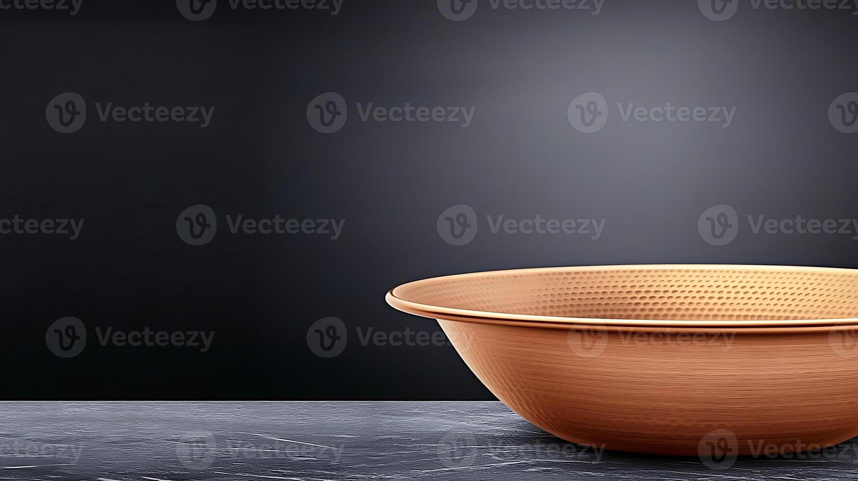 Copper colander placed on a dark marble surface with a minimalist background, ideal for kitchen use photo