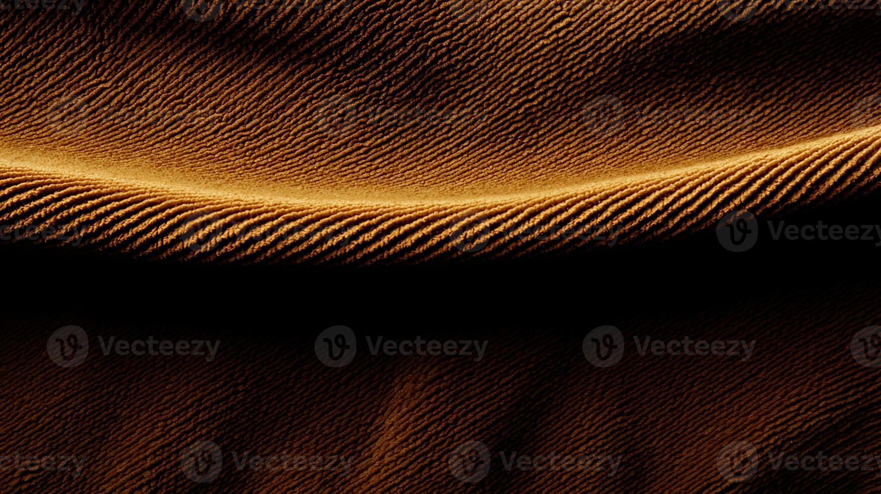 Close-up of flowing golden fabric showcasing elegant texture and soft shadows photo