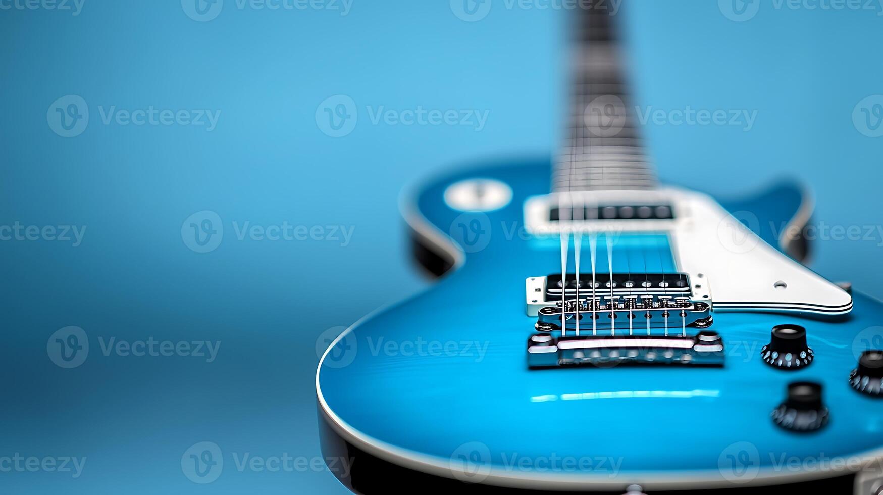 Close-up of a vibrant blue electric guitar on a smooth blue background, highlighting its design photo