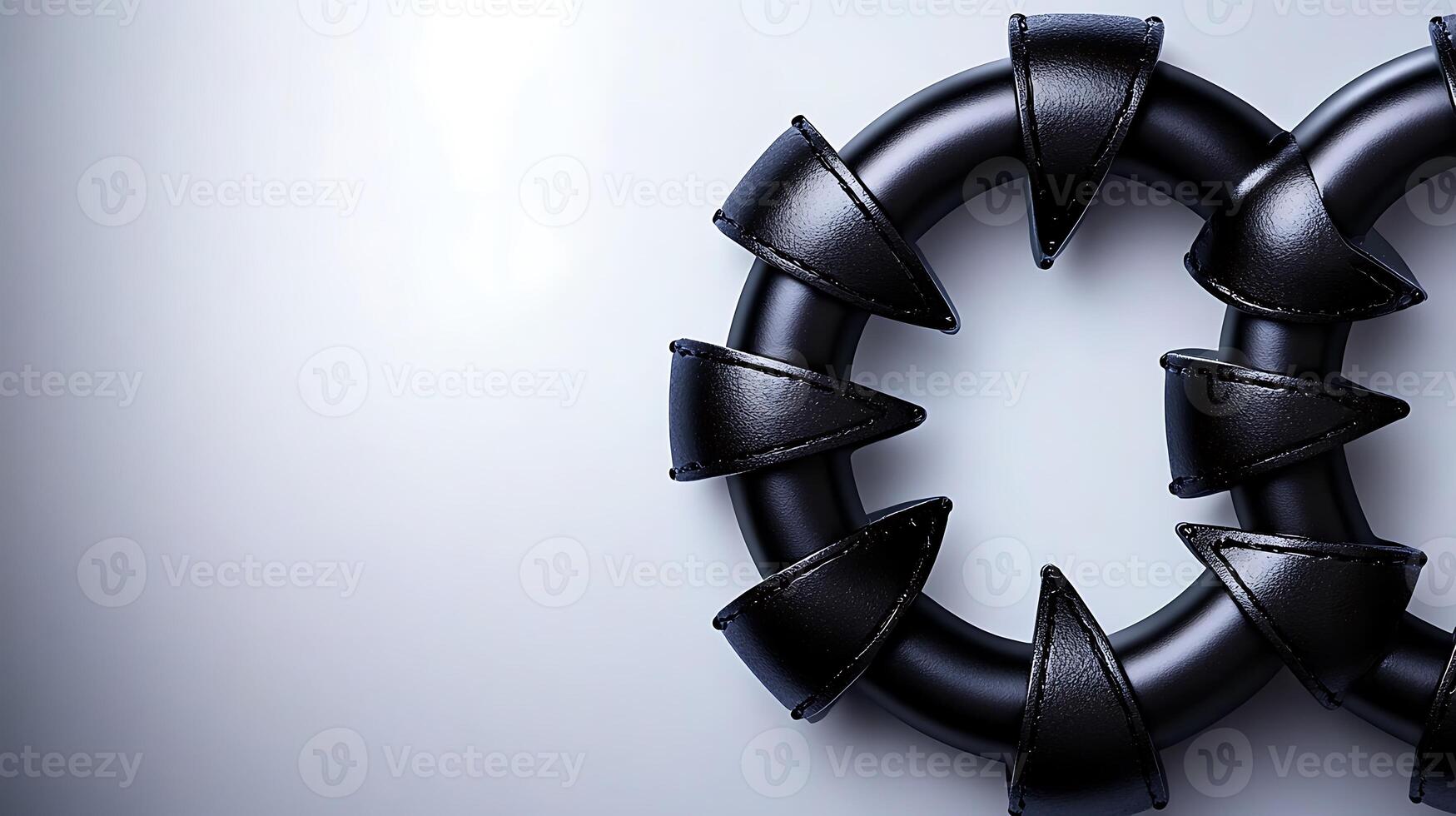 Close-up of black circular objects with pointed edges on a smooth gradient background photo