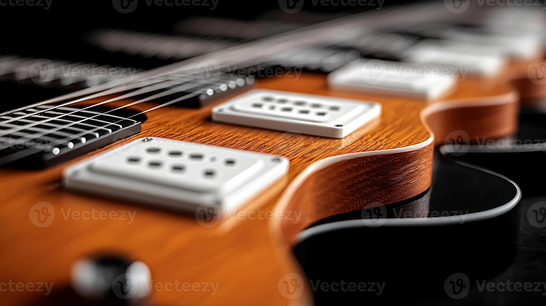 Close-up of an electric guitar showcasing its detailed body, pickups, and strings against a dark backdrop photo
