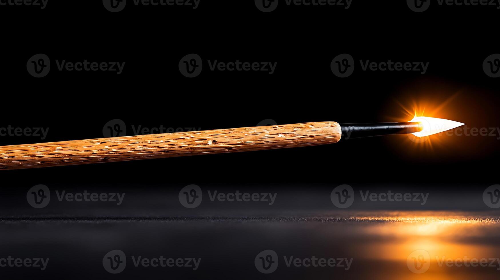 Close-up of a wooden spear with a glowing tip on a dark background, highlighting craftsmanship photo