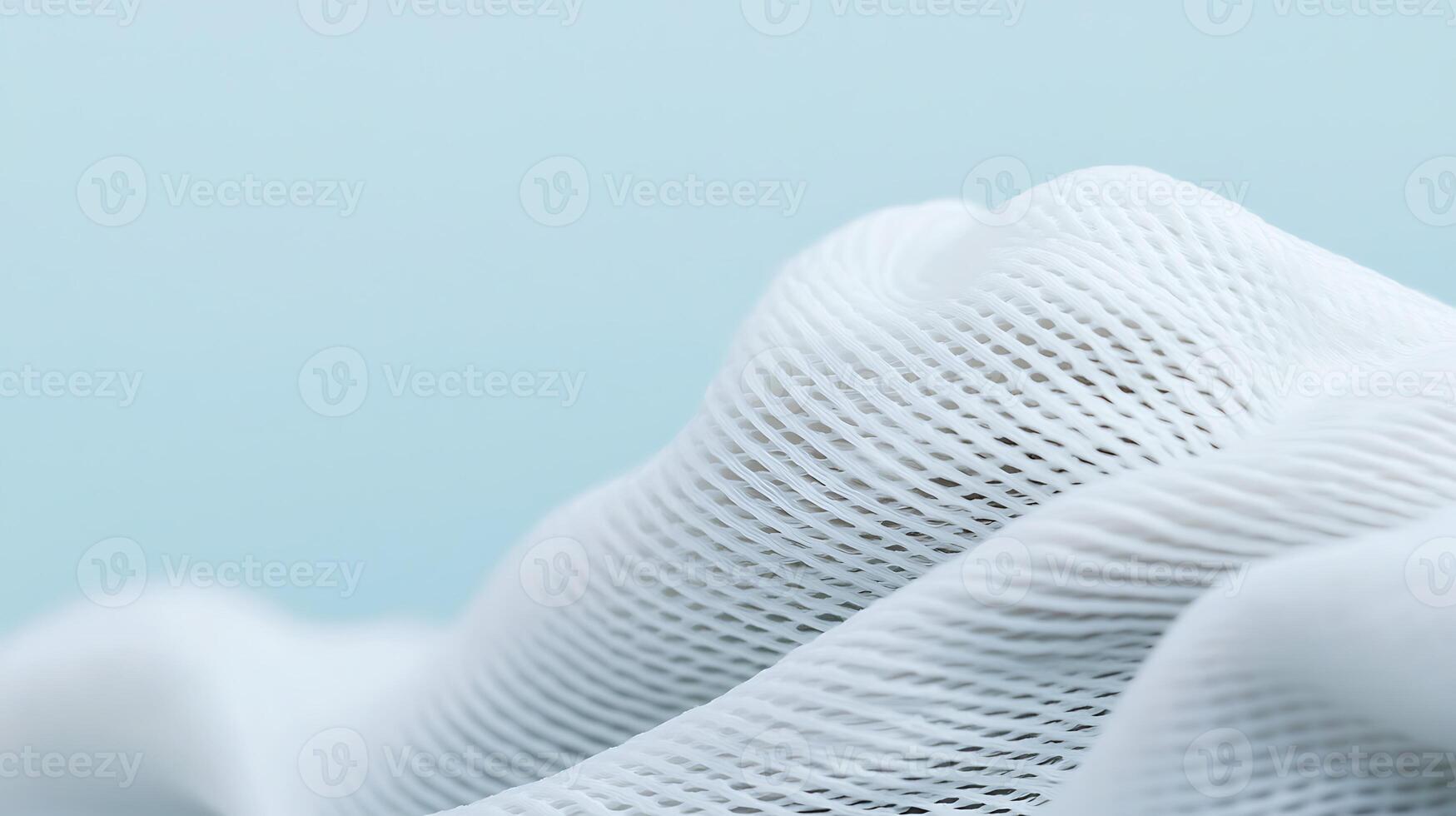 Close-up view of soft white fabric texture with gentle waves against a light blue background photo