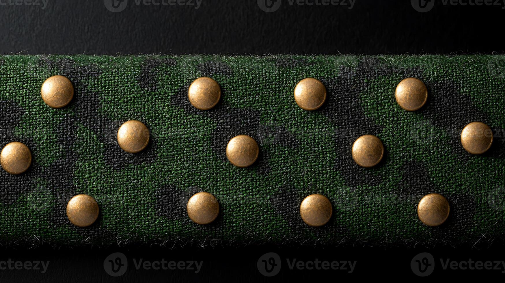 Close-up view of a textured green fabric with gold studs, showcasing a military-inspired design photo