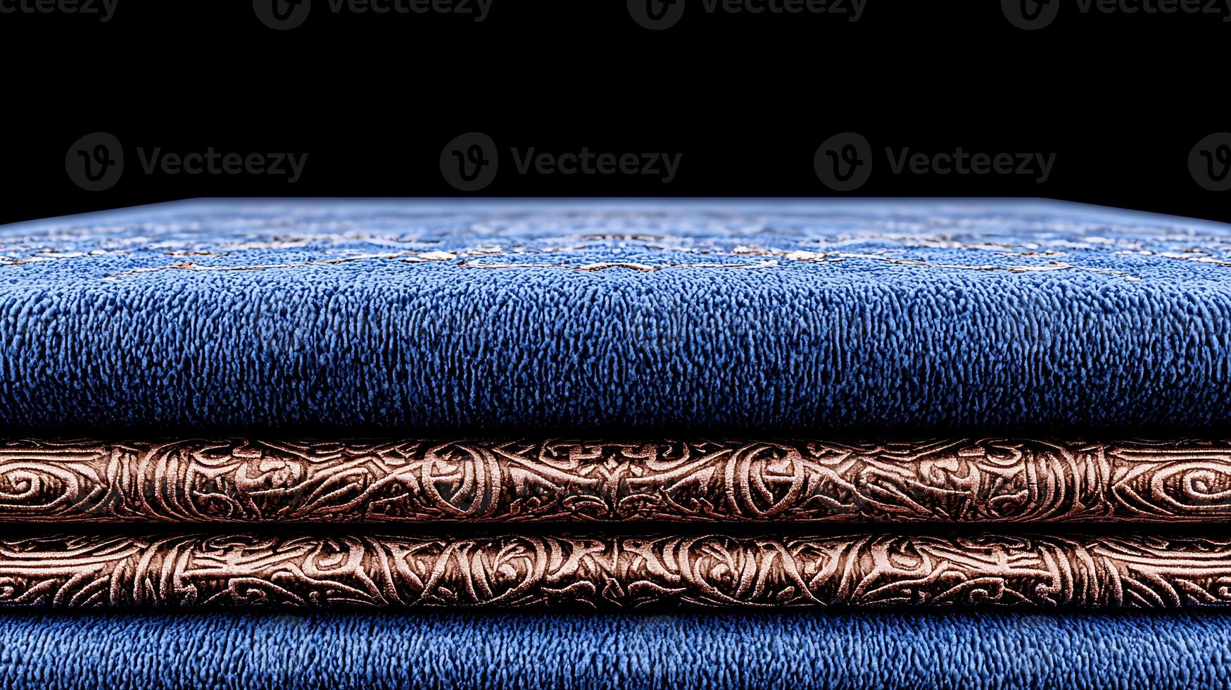 Close-up view of intricately designed blue fabric stacked with ornate copper accents, showcasing texture photo