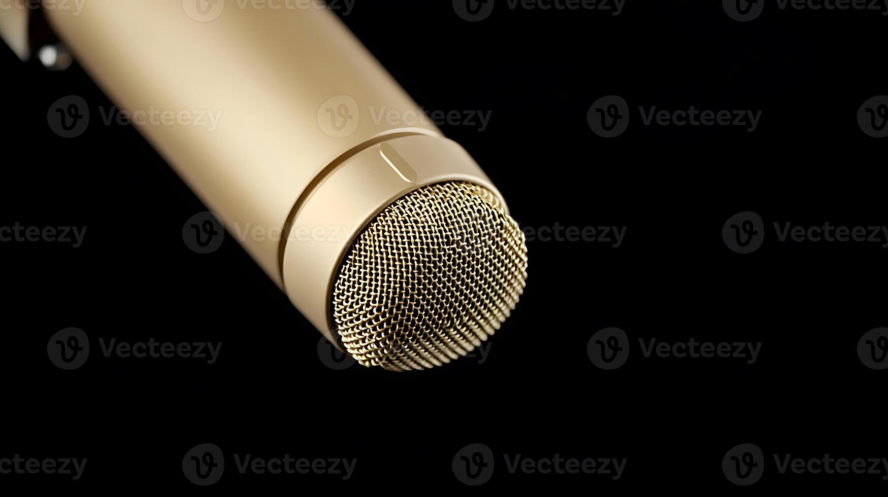 Close-up view of a gold microphone against a black background, highlighting its design and texture photo