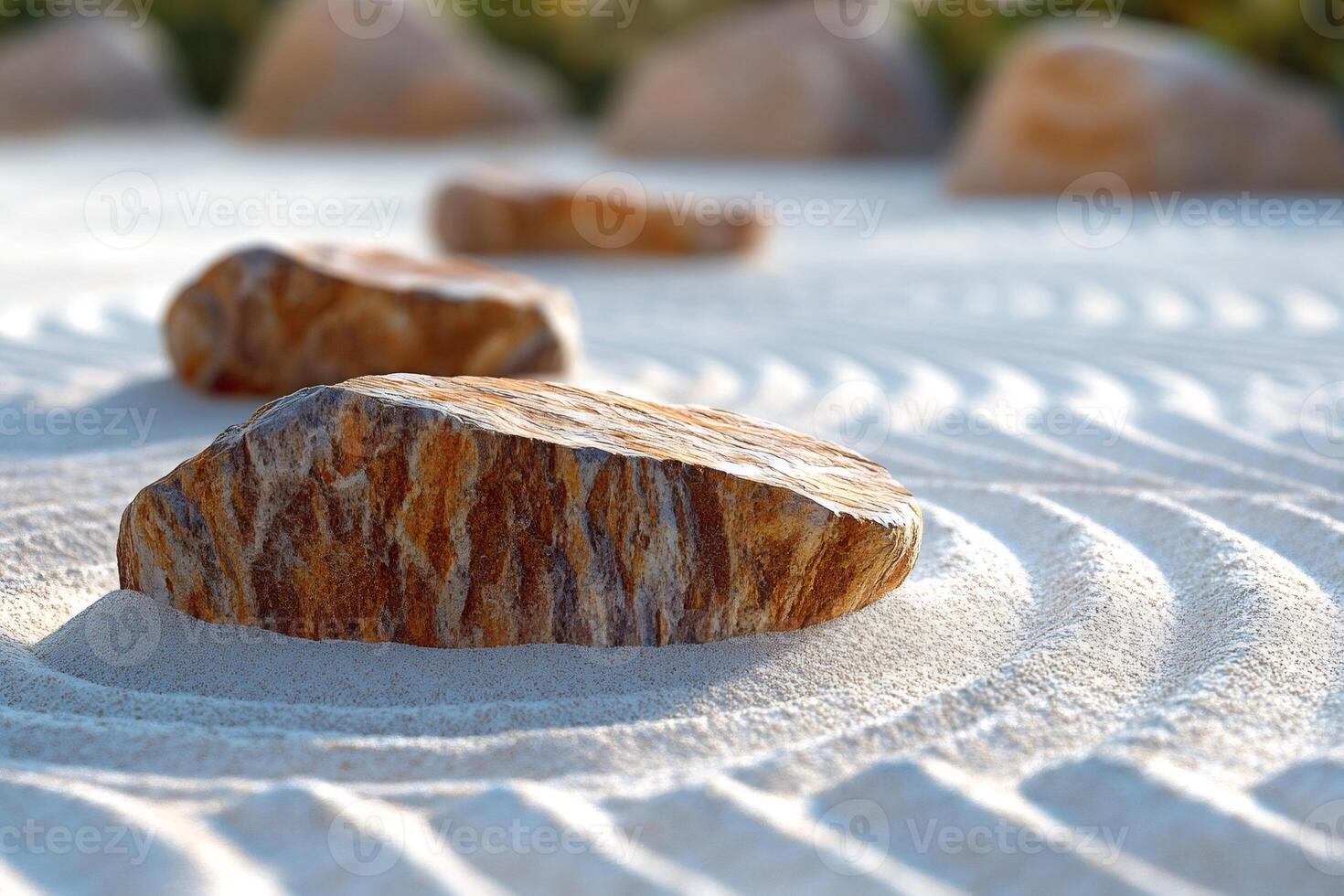 Stones resting on a serene white sand ripple pattern background representing zen garden photo