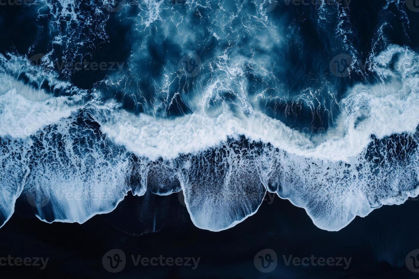 Ocean waves crashing on black sand beach, aerial view .. photo