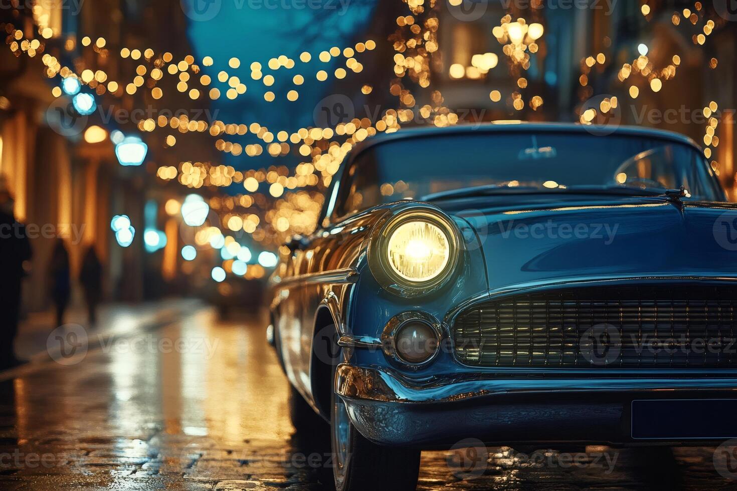 Classic car parked on a cobblestone street with christmas lights at dusk photo