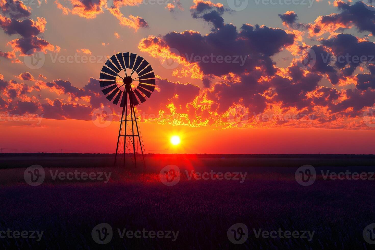 Multi blade windmill standing in lavender field at sunset with dramatic clouds photo