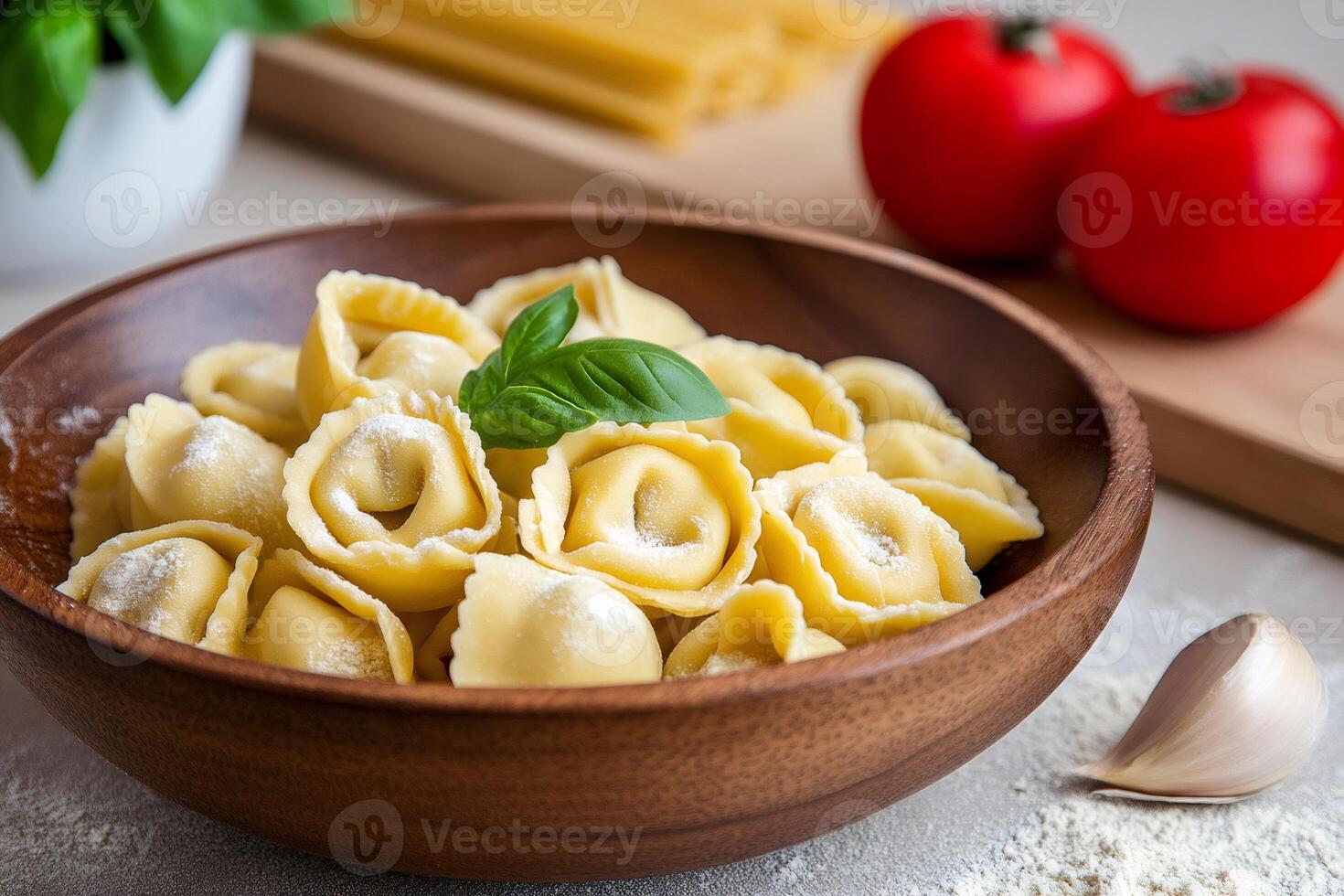 Delicious tortellini with basil and sprinkled parmesan cheese in wooden bowl photo