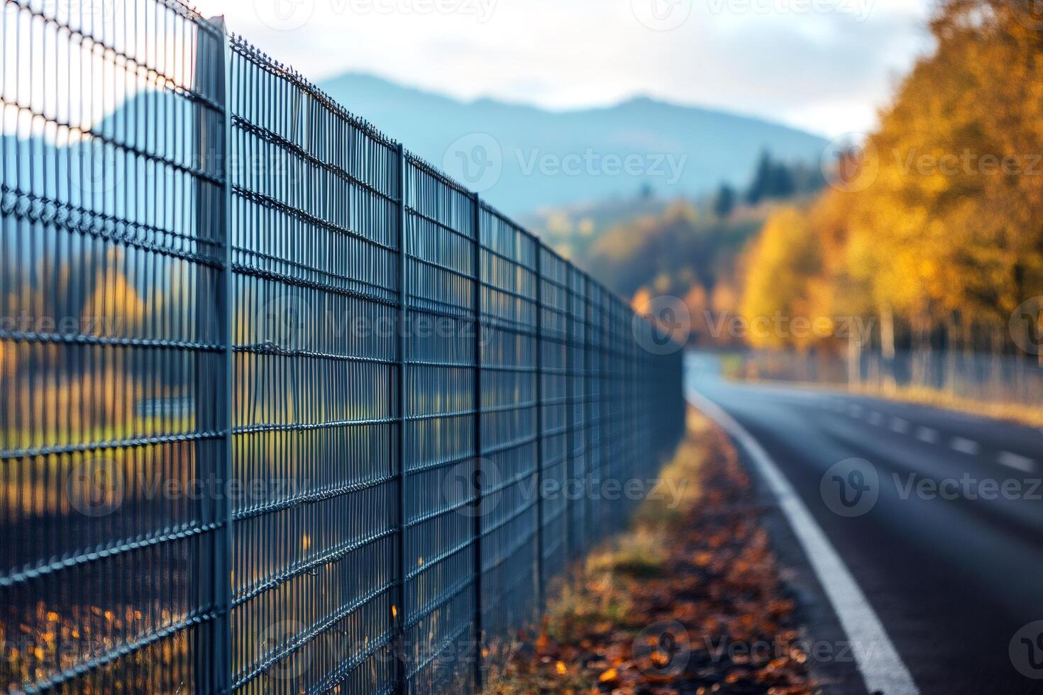 Metal fence protecting the road during fall season photo