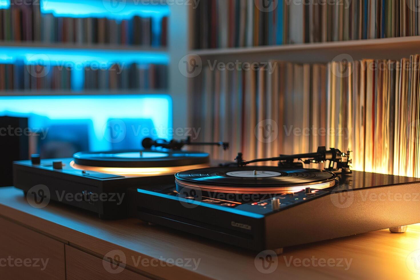 Two turntables playing vinyl records in a cozy room with bookshelves and blue backlight photo