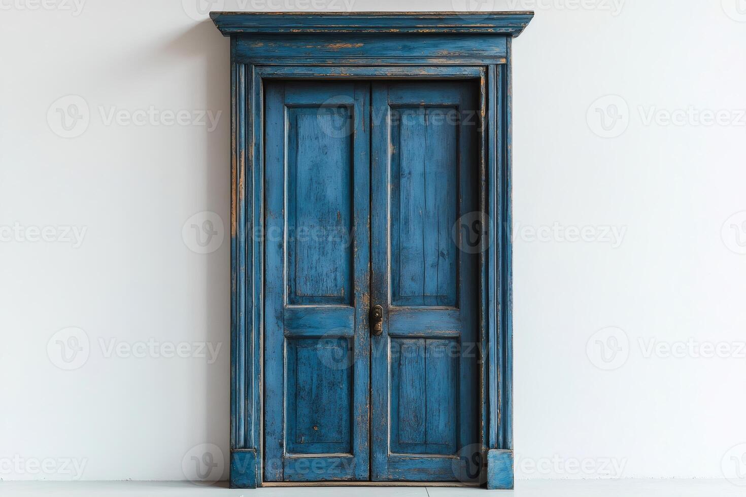 Old blue double door showing signs of age and wear in white room photo