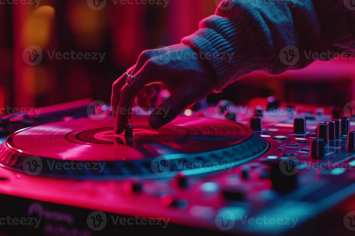 Dj playing music at a nightclub with colorful lighting photo