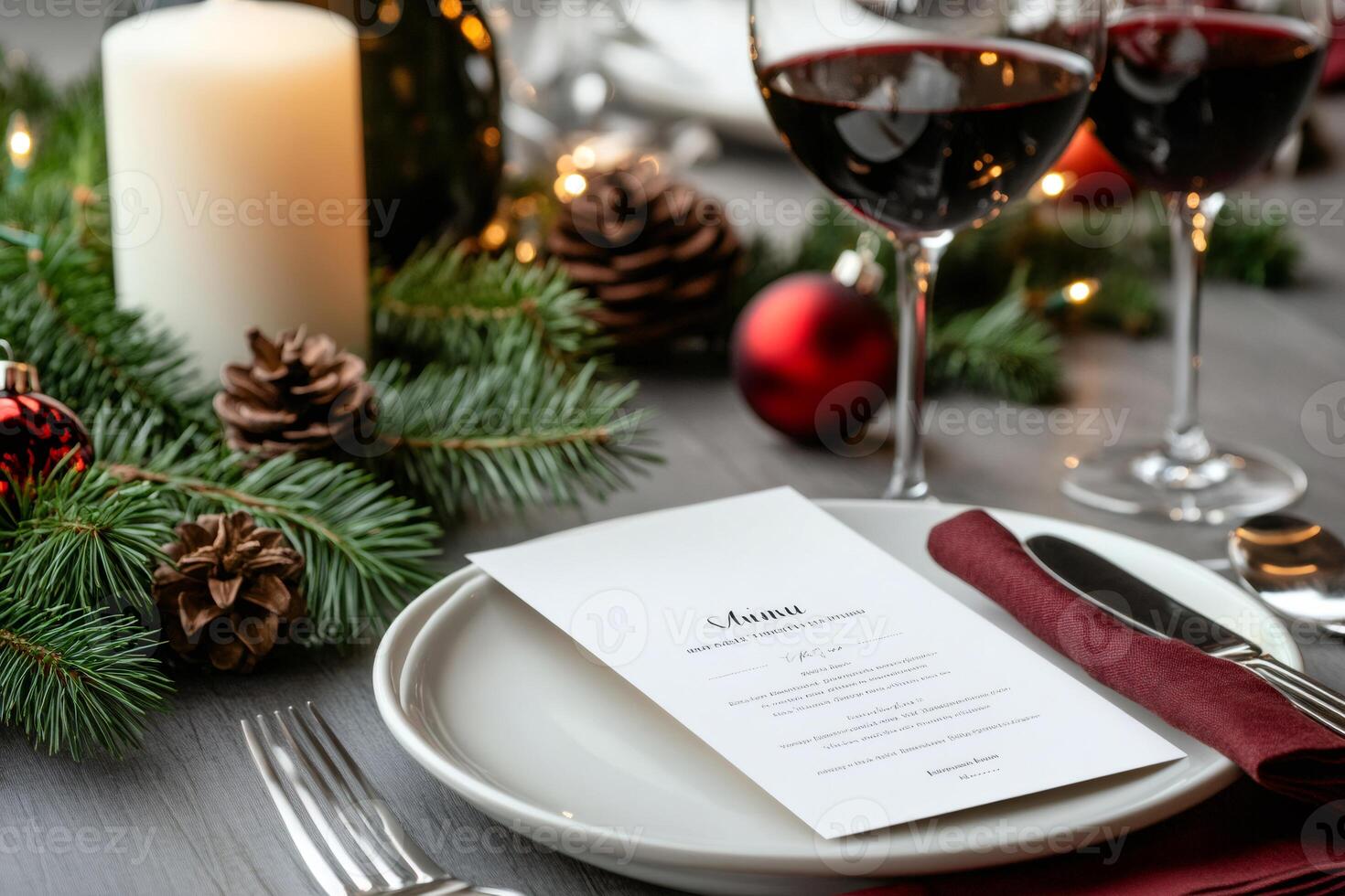 Christmas dinner table setting with menu, red wine, and festive decorations photo