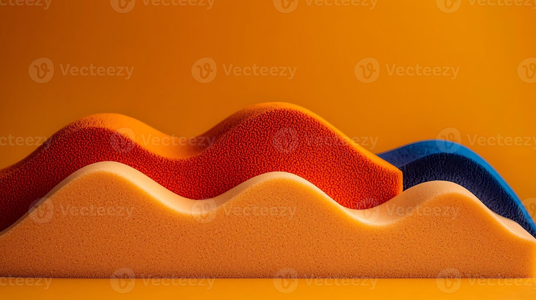 Colorful foam waves in vibrant orange, blue, and yellow against a bright orange background photo