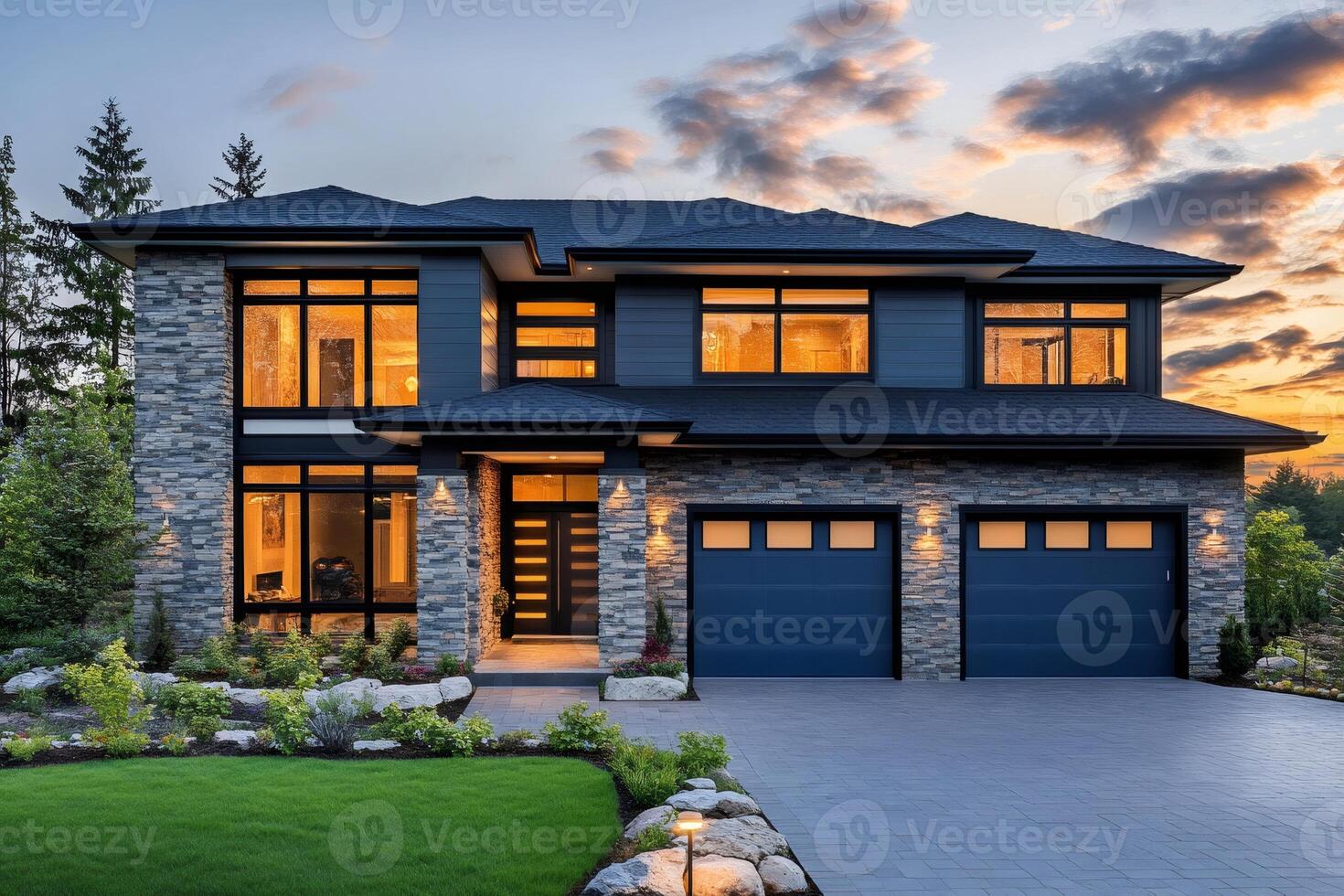 Modern luxury home exterior with illuminated windows at dusk photo