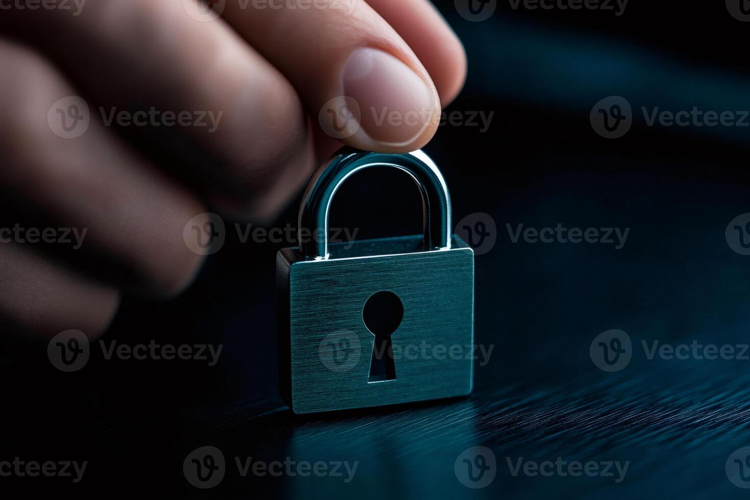 Hand holding small padlock protecting information security photo