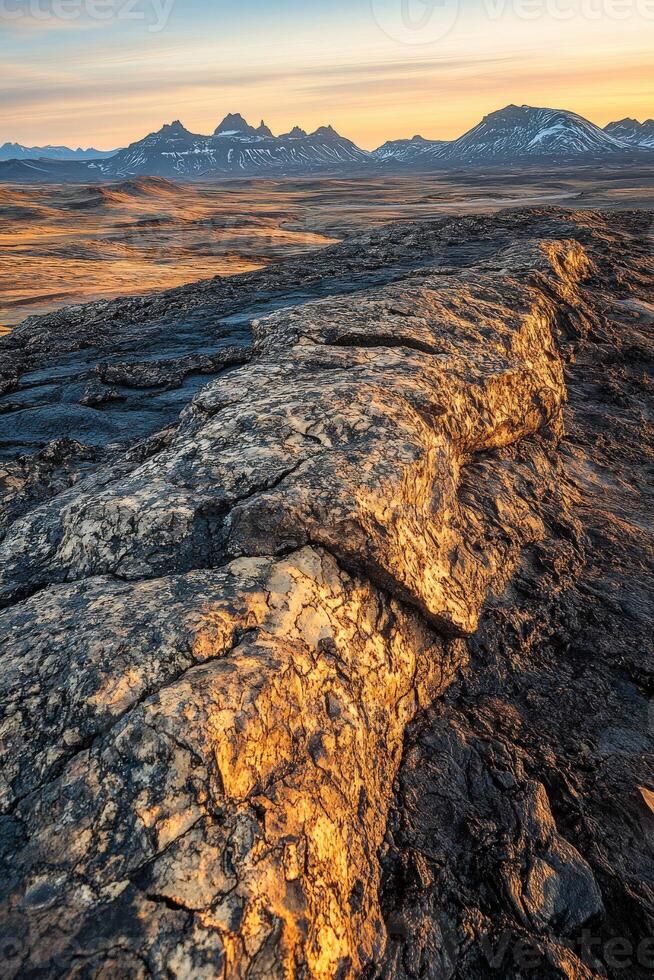 The sun sets over the mountains in iceland photo