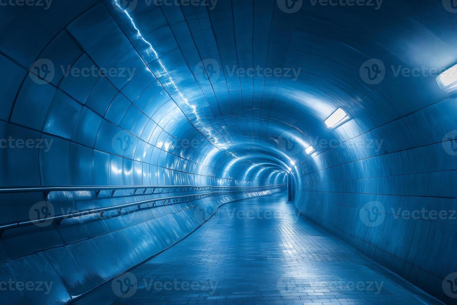 Empty modern pedestrian tunnel with blue lights and metal walls photo