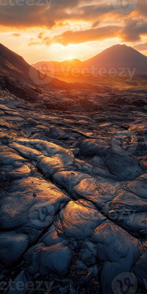 A sunset over a lava field photo