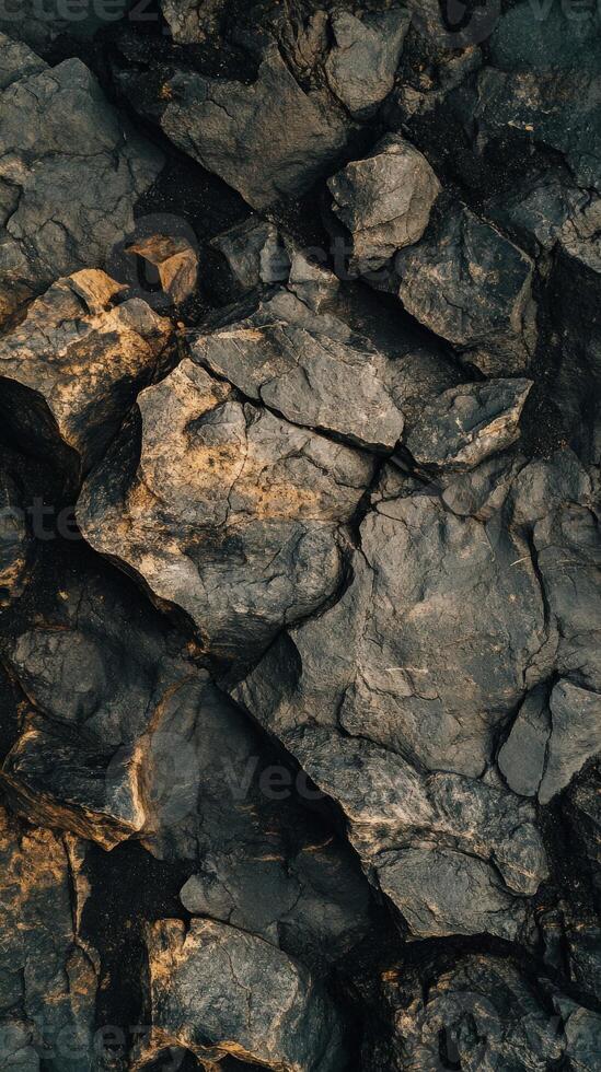 A close up of a rock wall with some black and white rocks photo