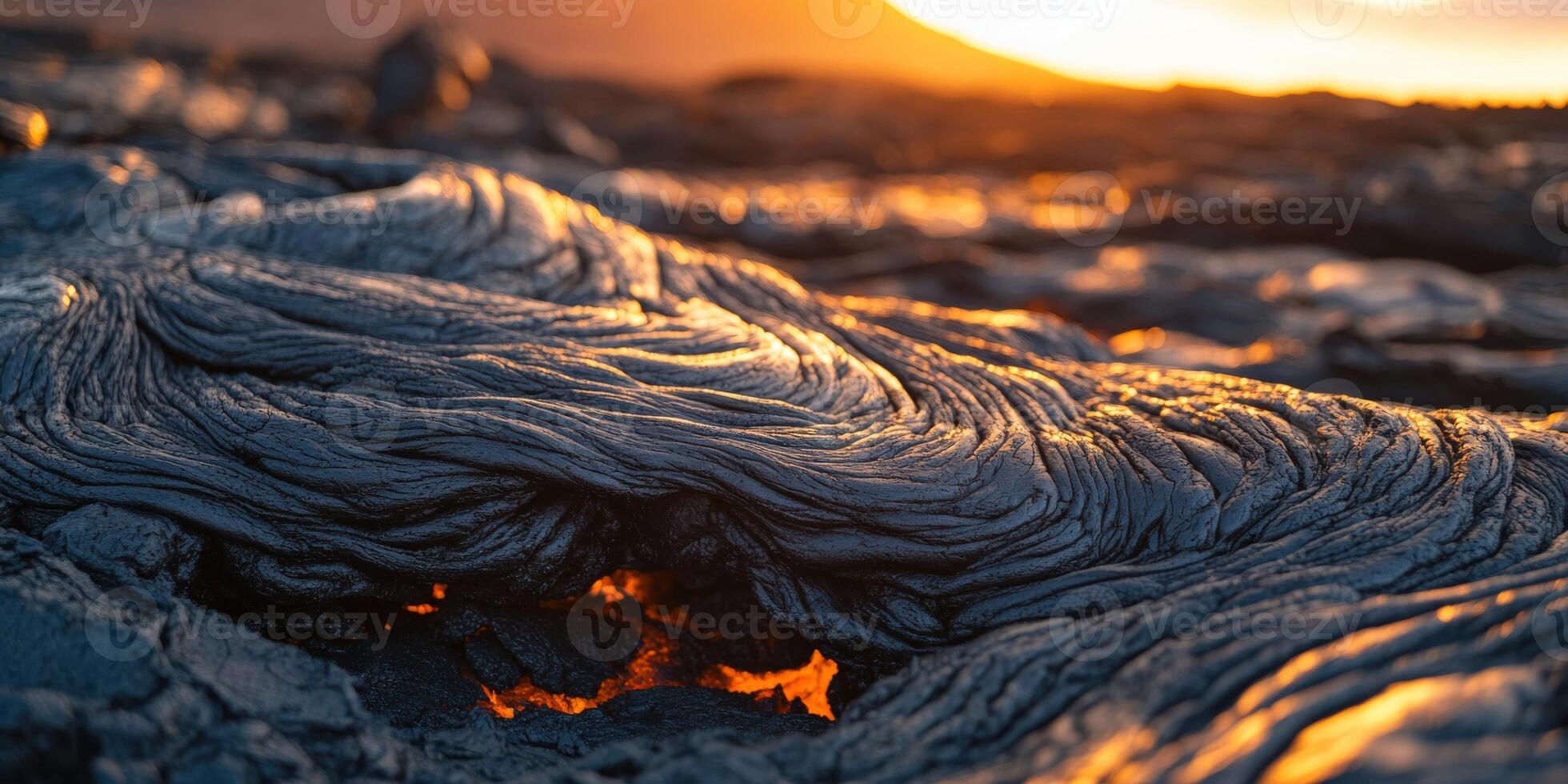 A lava flow with the sun setting behind it photo