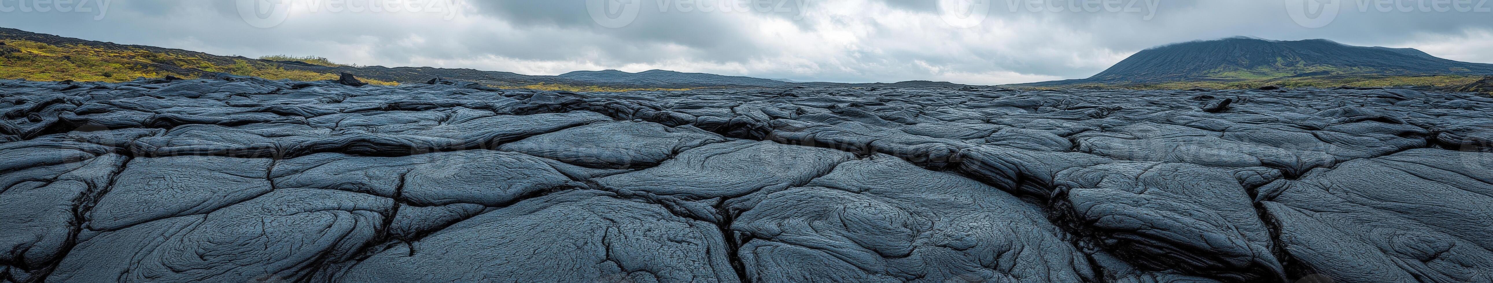 Lava landscape with hardened flow beneath overcast sky near volcanic site photo
