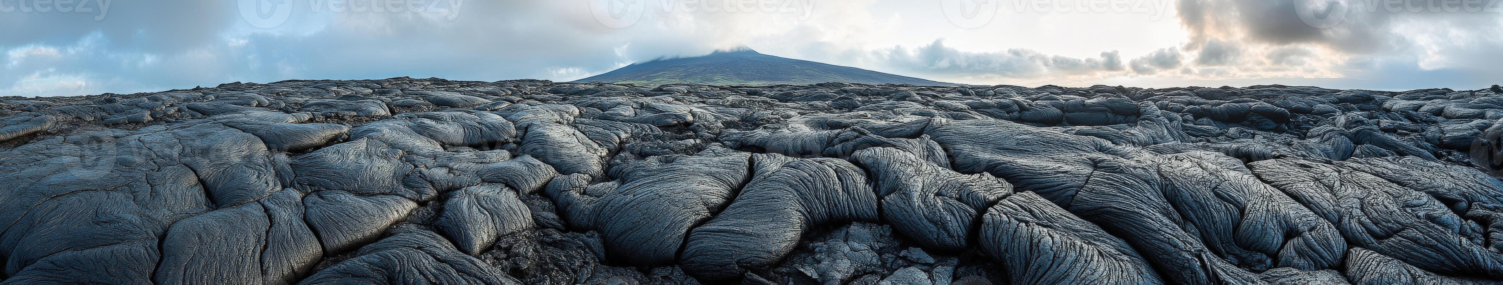 Majestic view of a volcanic landscape under a cloudy sky at dusk photo