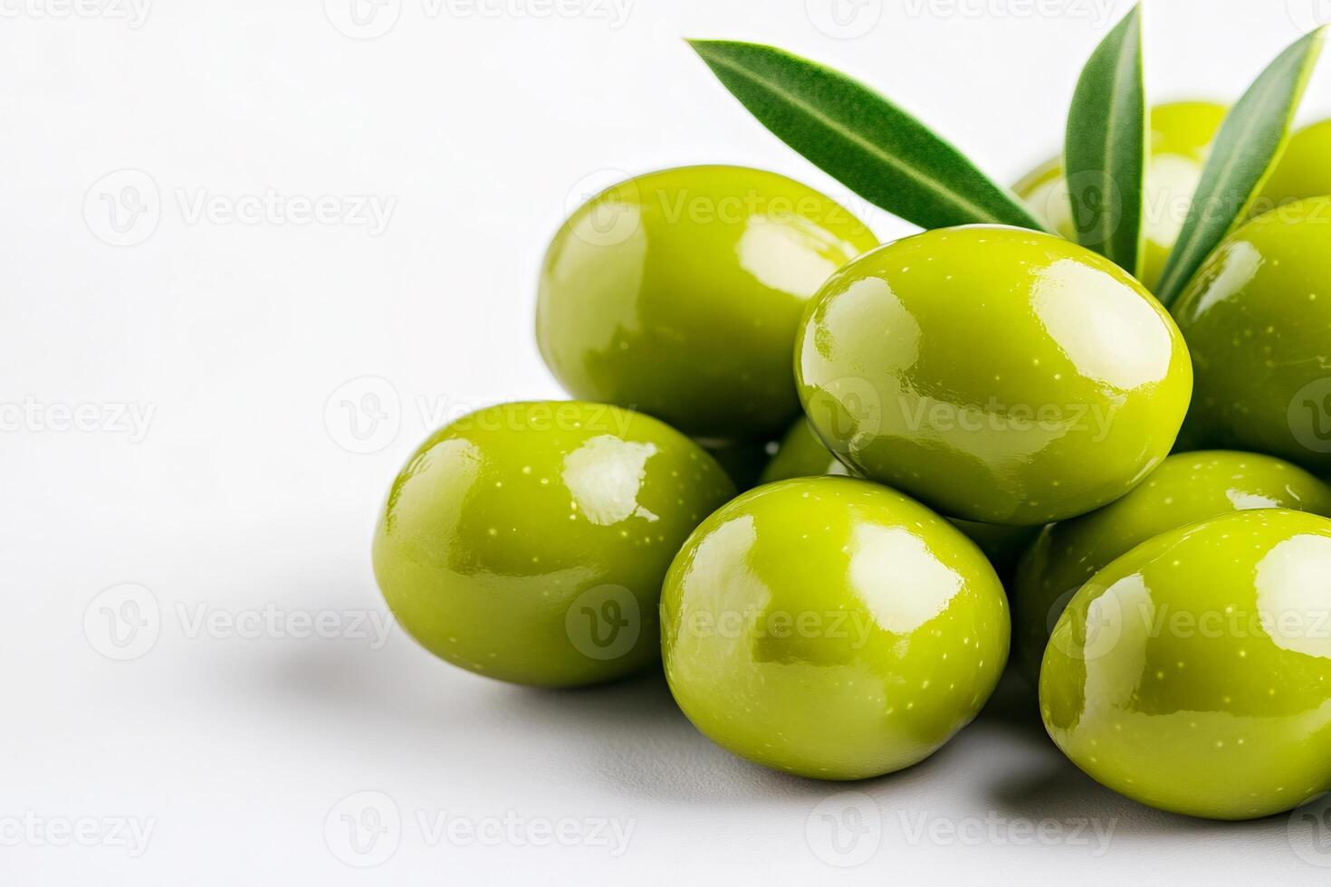 Fresh green olives with leaves resting on white background . . photo